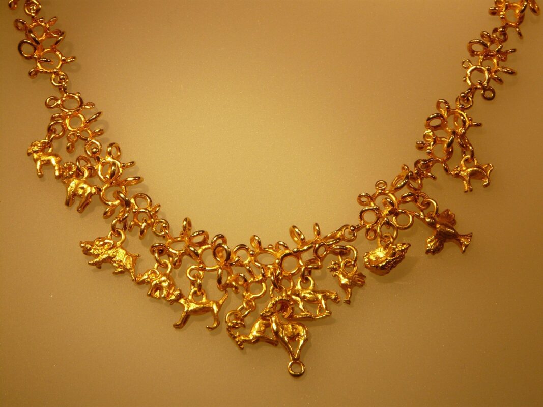 A fine gold chain necklace laid flat